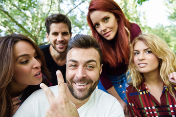 Group of friends taking selfie in urban background