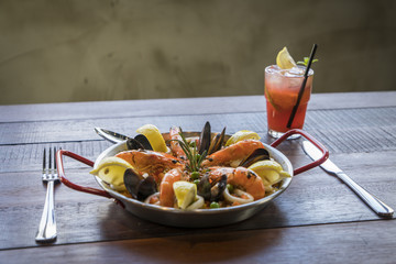 Paella with seafood vegetables and saffron served in the traditional pan