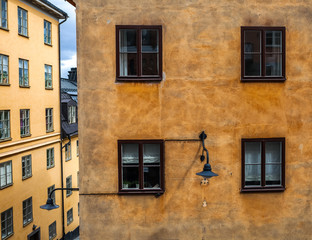 Fototapeta na wymiar Close-up of windows of yellow old building in Stockholm, Sweden