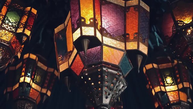 Colorful arabic lanterns hanging under blue tent, close up. Shot with sony a7s on a slider