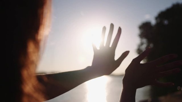 Sun in hands. Woman hand catching a sun against beautiful sunset on horizon. Nature. Vacation. Hope. Carpe diem. Opportunity concept. Freedom, hippie generation. Full HD 1080p