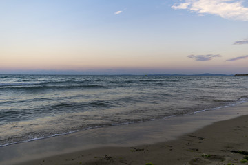 Rough and choppy sea water with sunset sky