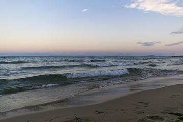 Rough and choppy sea water with sunset sky