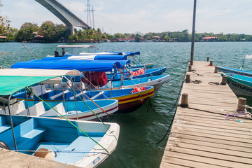 Fototapeta premium FRONTERAS, GUATEMALA - MARCH 10, 2016: Boats at Rio Dulce river at the pier in Fronteras town, Guatemala
