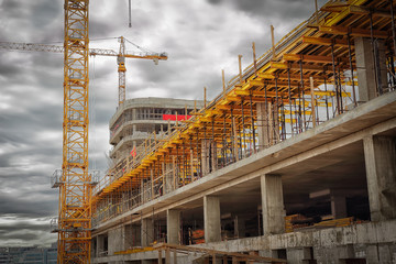 Fototapeta premium Construction site. Construction cranes, monolithic concrete walls, formwork for concrete.