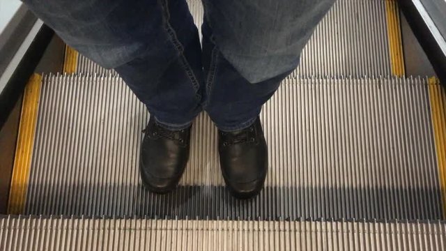 Man going up on a moving escalator