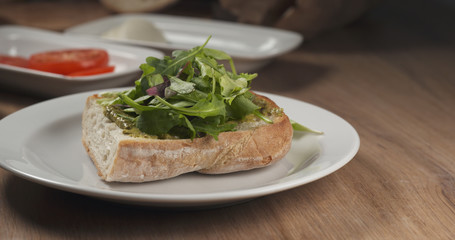 making italian sandwich with speck and mozzarella apply rocket salad