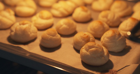 cooking profiteroles in oven closeup