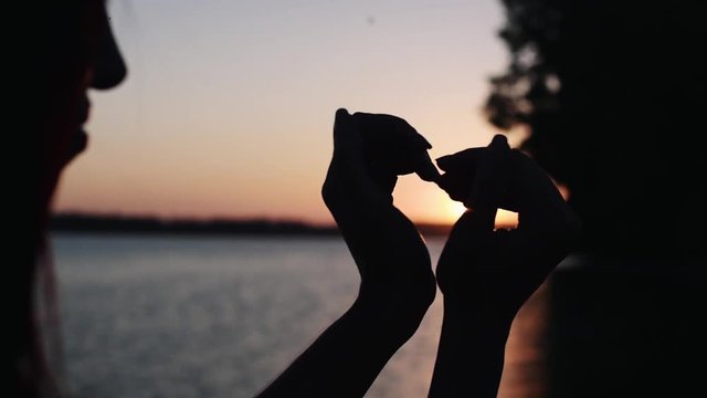 Sun in hands. Woman hand catching a sun against beautiful sunset on horizon. Nature. Vacation. Hope. Carpe diem. Opportunity concept. Freedom, hippie generation. Full HD 1080p