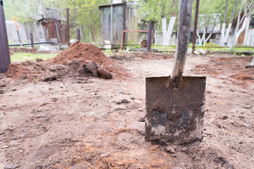 Dirty shovel dig in sand
