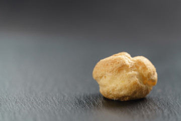 profiterole on slate background with copy space