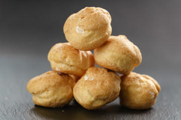 profiteroles on slate background closeup