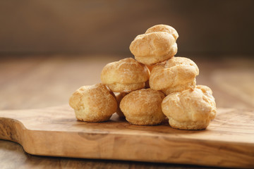 profiteroles on olive board closeup