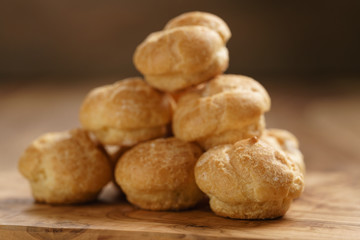 profiteroles on olive board closeup