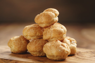 profiteroles on olive board closeup