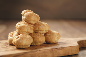 profiteroles on olive board closeup