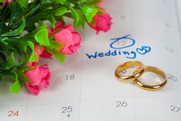 Duo ring in box with Wedding note on a calendar sets a reminder for the wedding day.