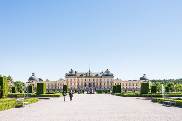 Fototapeta na wymiar View over Drottningholm Palace and park on a sunny summer day. Home residence of Swedish royal family. Famous landmark and tourist destination in Stockholm, Sweden