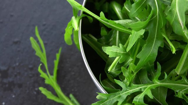 Fresh Arugula rotating on a wooden plate (not loopable; 4K)