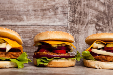 Home made burgers on wooden plate. Fast food. Unhealthy snack