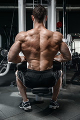 Naklejka na ściany i meble Strong bodybuilder man at the gym
