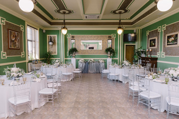 Interior of a wedding decorated restaurant in white and silver colors