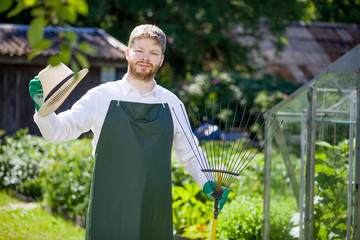 young gardener with a professional tools and equipment