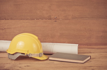 yellow construction safety helmet on wood