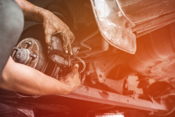 Car mechanic repairing brakes pads auto repair in garage, Professional car service automobile station
