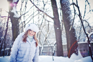 Beautiful girl in a winter snowy park