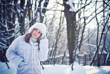 Beautiful girl in a winter snowy park