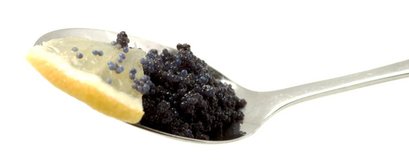 Spoon With Black Caviar And Lemon Slice On White Background