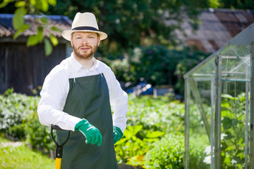 portrait of a smiling greenhouse worker