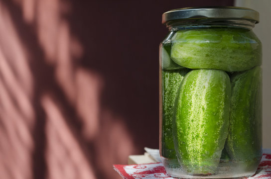 Pickled homemade sunny cucumbers in the glass jar