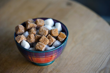 Bowl of white and brown sugar cubes