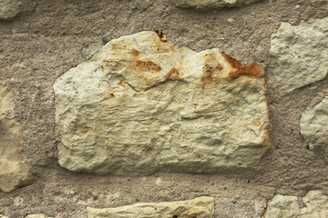 Close view on big stone in old wall ,interesting background