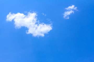 Blue sky background with white clouds on sunny summer or spring day.