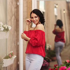Young beautiful caucasian brunette woman with hairstyle posing at summer terrace with with on city...