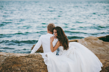 Beautiful wedding couple on a walk by the sea