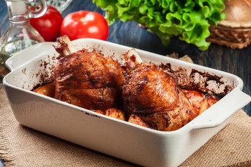 Roasted turkey knuckle with potatoes and vegetable