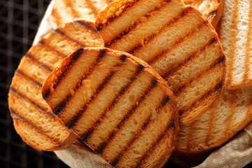 Fresh toast in basket on black background
