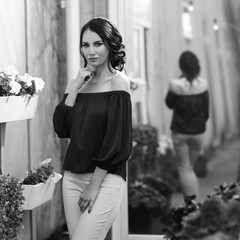 Young beautiful caucasian brunette woman with hairstyle posing at summer terrace with with on city...