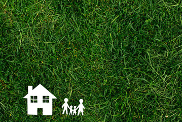 family and the house against the background of greens