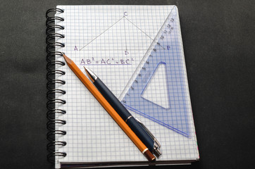 Page with formulas and the Pythagorean theorem with pen, pencil and ruler