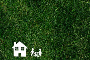 family and the house against the background of greens