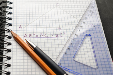 Page with formulas and the Pythagorean theorem with pen, pencil and ruler