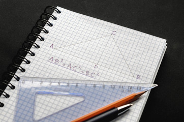 Page with formulas and the Pythagorean theorem with pen, pencil and ruler