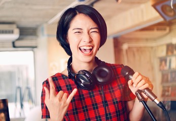 Asian woman joyful with music.