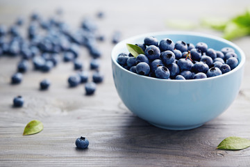 Small Bowl of Organic Blueberries on Wooden Table