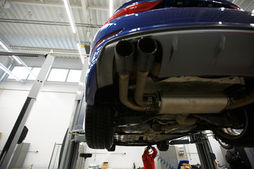 People work in car repair at a service station